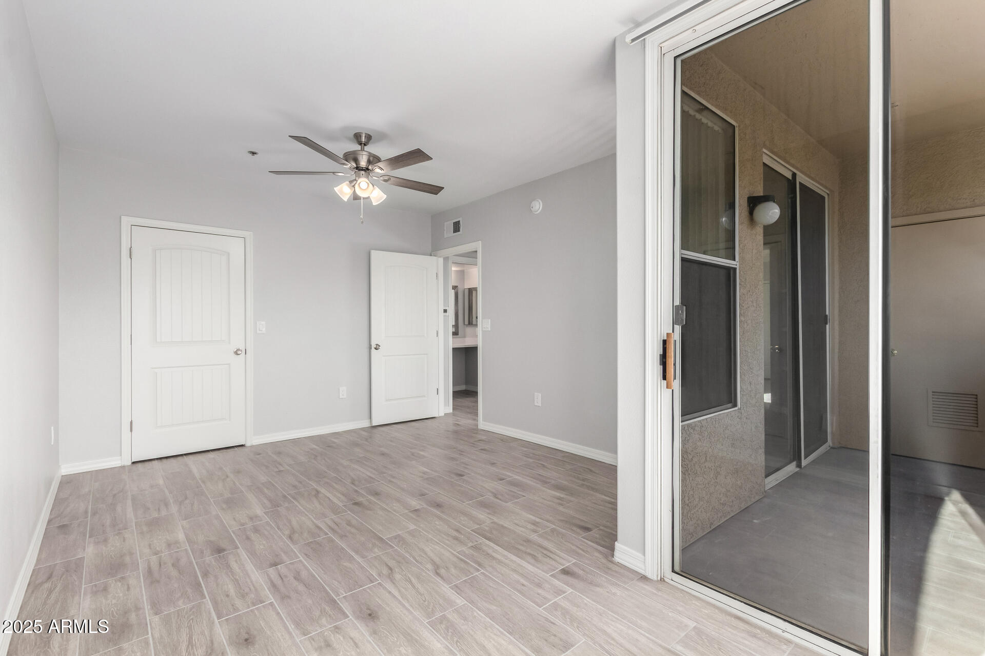 2134 East Broadway Road, Unit 1035 Tempe, AZ 85282 - Photo 19 of 31 a view of an empty room with a ceiling fan