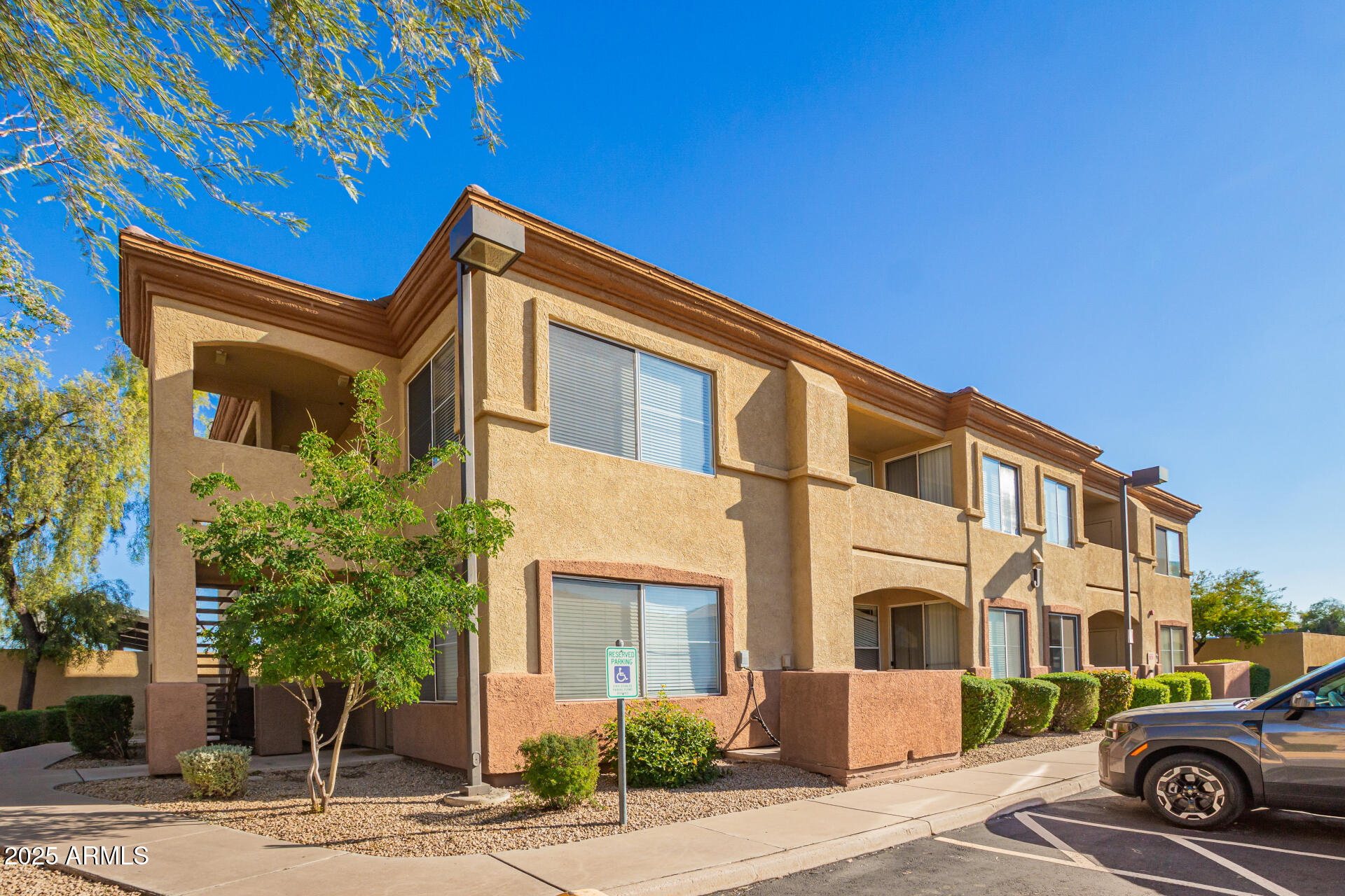 2134 East Broadway Road, Unit 1035 Tempe, AZ 85282 - Photo 2 of 31 a front view of a house with parking