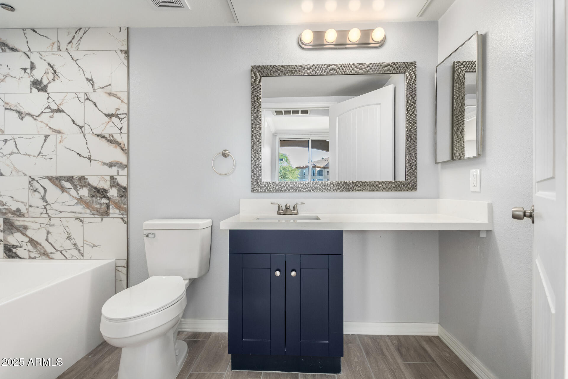 2134 East Broadway Road, Unit 1035 Tempe, AZ 85282 - Photo 21 of 31 a bathroom with a sink a toilet a mirror and shower