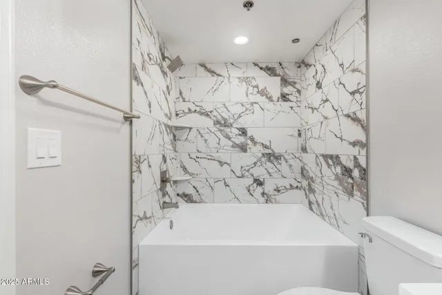 a bathroom with a bathtub and shower