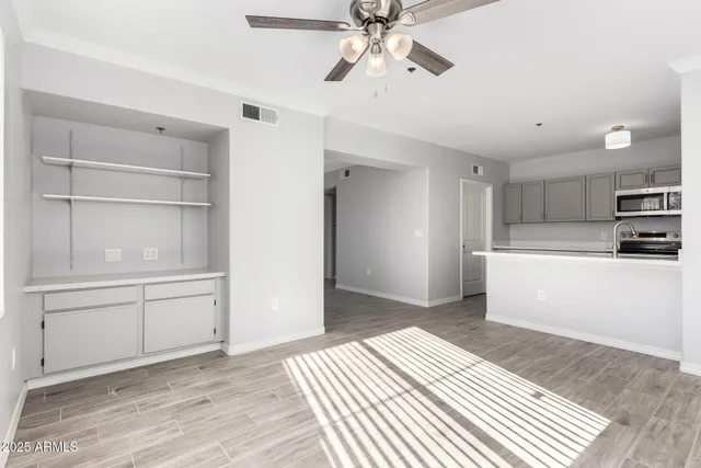 a kitchen with a refrigerator and white cabinets