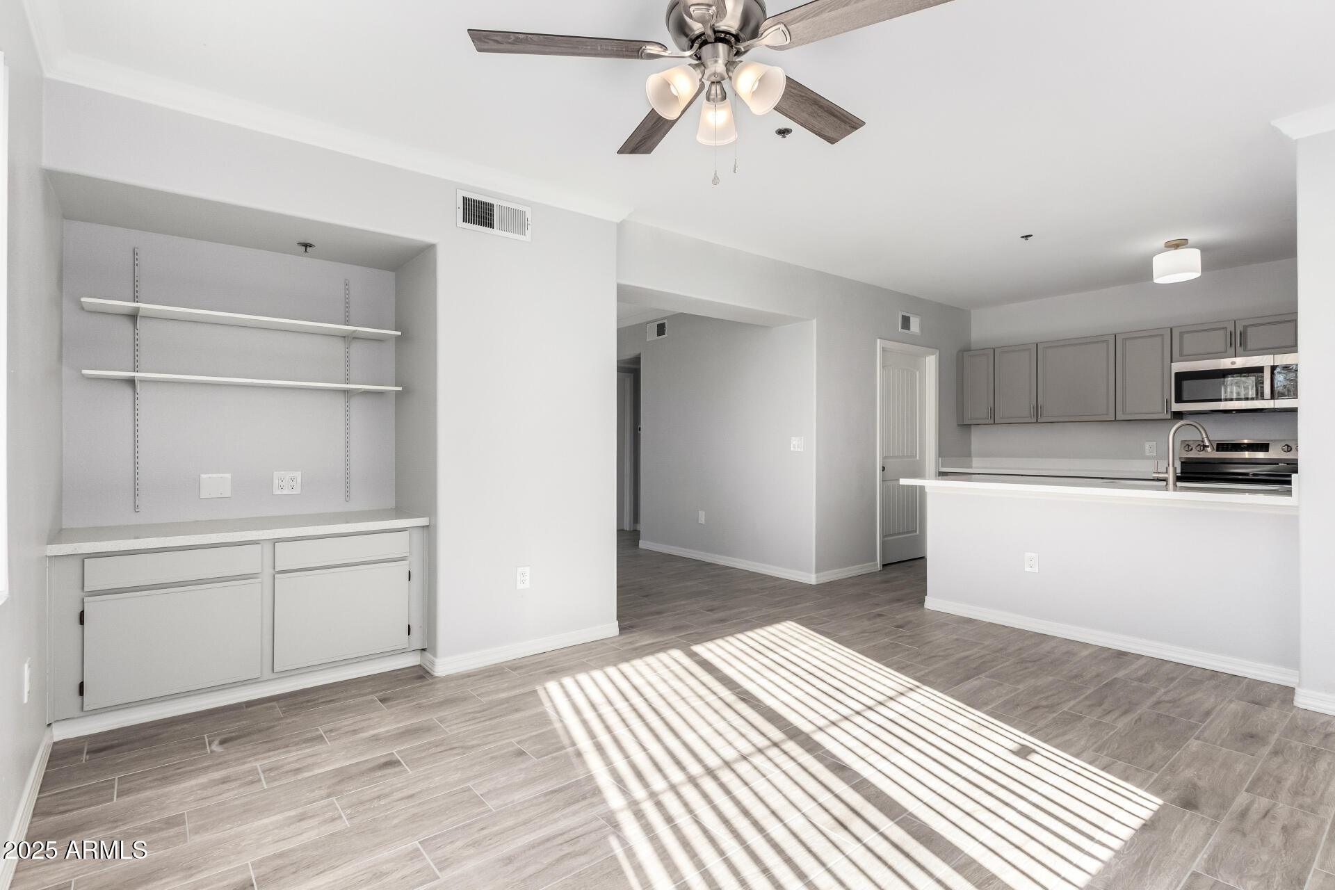 2134 East Broadway Road, Unit 1035 Tempe, AZ 85282 - Photo 8 of 31 a kitchen with a refrigerator and white cabinets