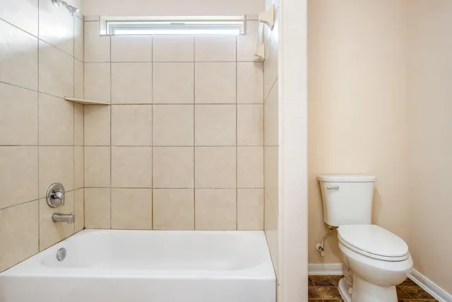 a white bath tub sitting next to a white toilet