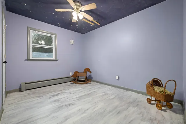 a room with gym equipment and a chandelier