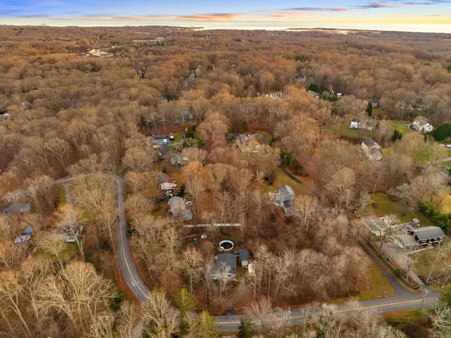 an aerial view of house with yard and mountain view in back