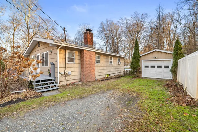 a view of a house with a yard and wooden fence