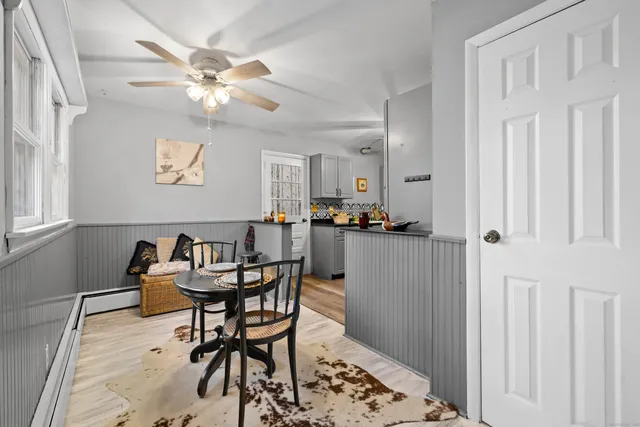 a dining room with furniture and window