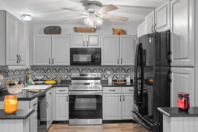 a kitchen with stainless steel appliances a stove refrigerator and microwave