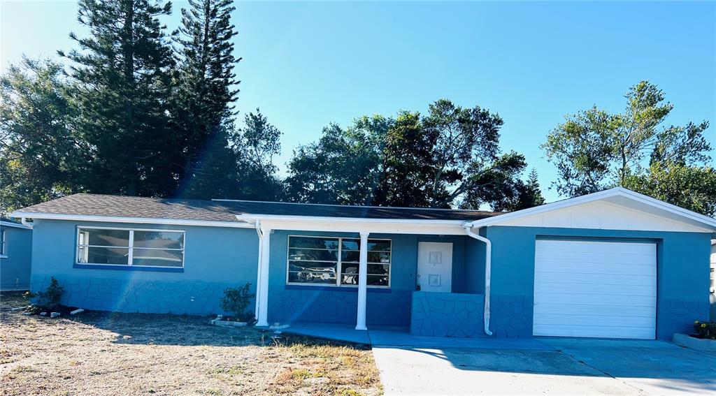 7340 Gulf Highlands Drive Port Richey, FL 34668 - Photo 1 of 1 a front view of a house with a yard