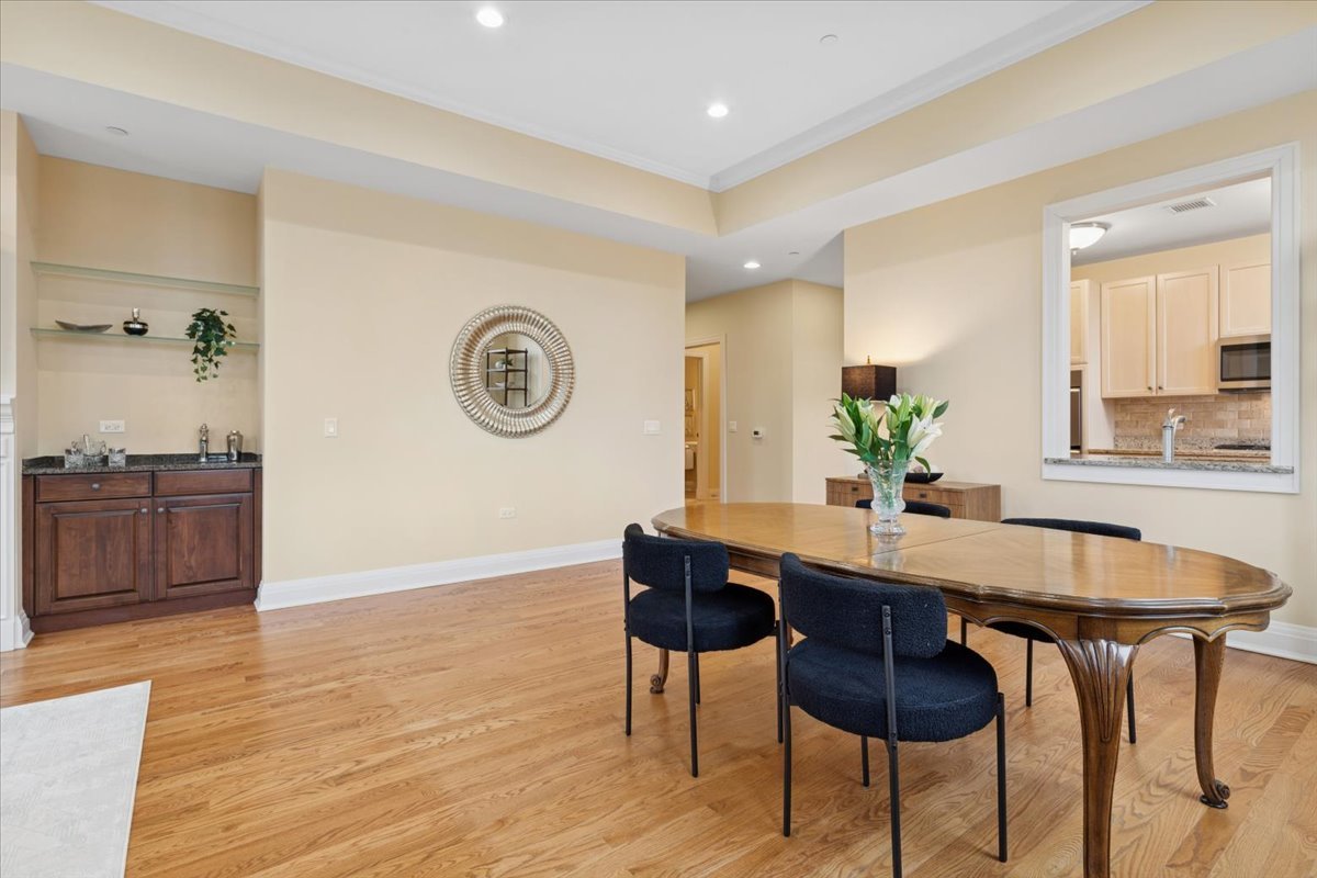 1041 Ridge Road, Unit 304 Wilmette, IL 60091 - Photo 16 of 30 a view of a dining room with furniture and wooden floor