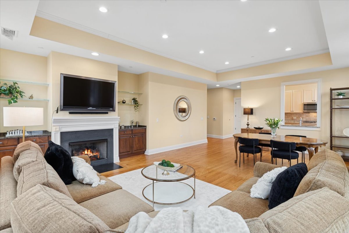 1041 Ridge Road, Unit 304 Wilmette, IL 60091 - Photo 3 of 30 a living room with furniture a fireplace and a flat screen tv