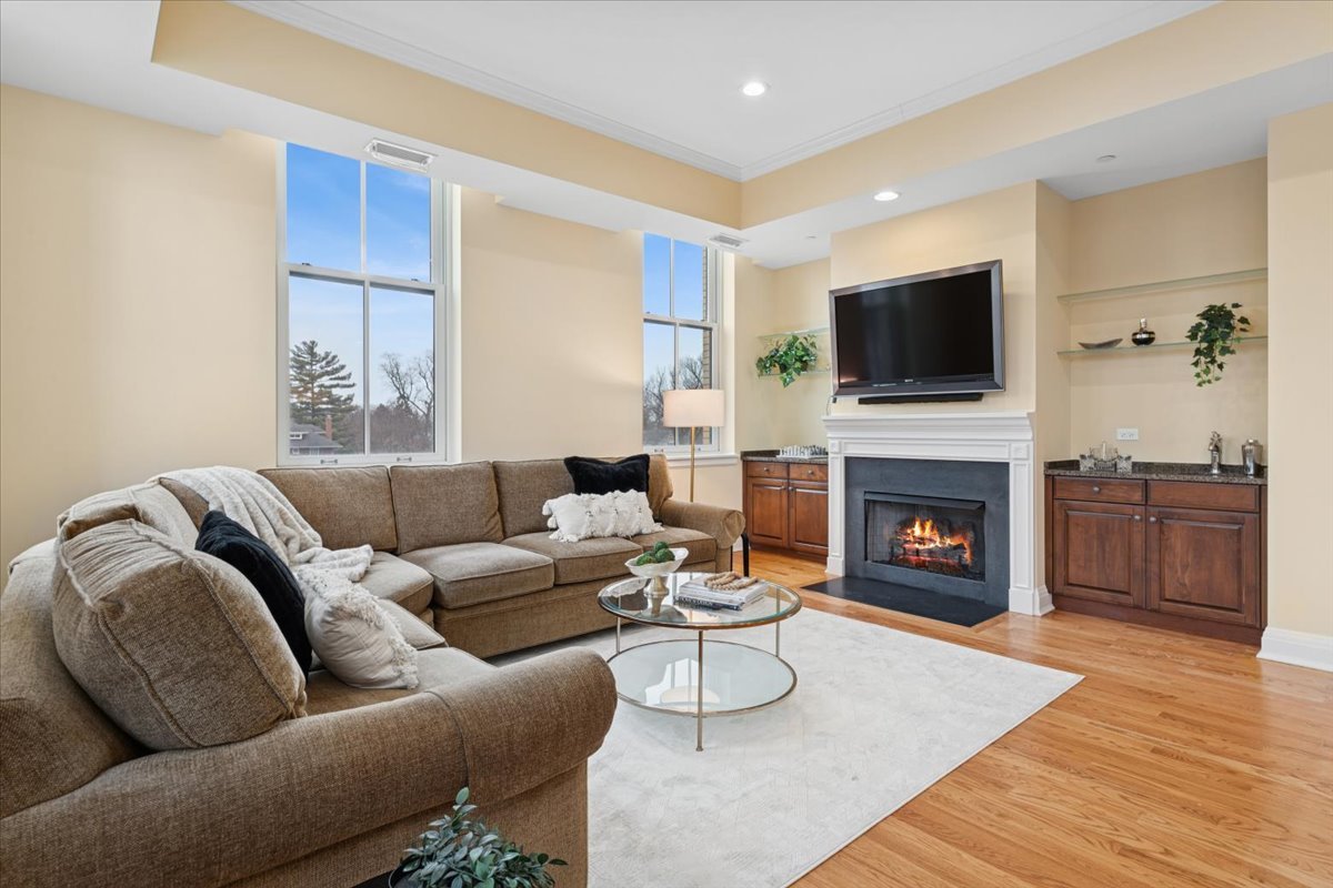 1041 Ridge Road, Unit 304 Wilmette, IL 60091 - Photo 4 of 30 a living room with furniture a flat screen tv and a fireplace