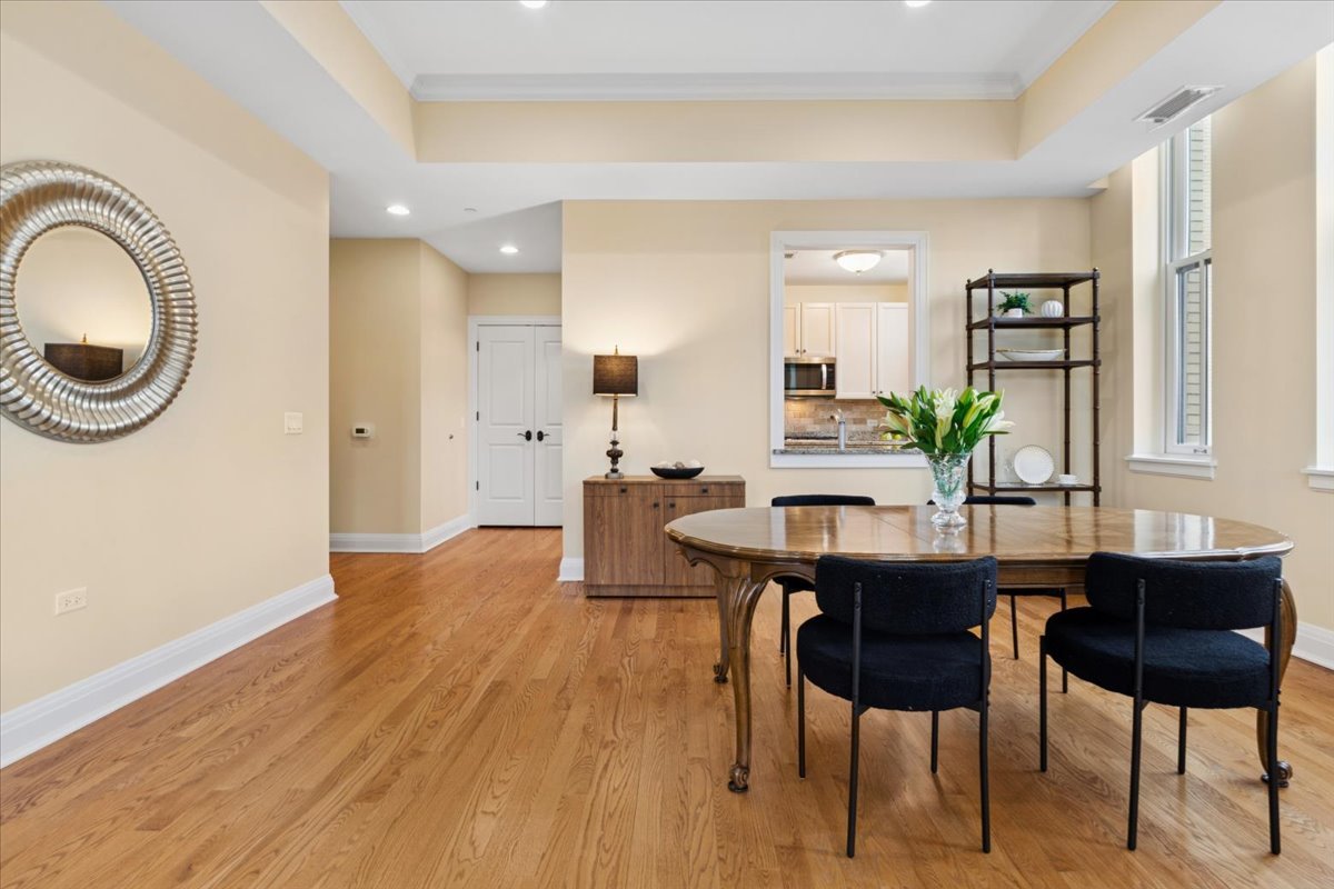 1041 Ridge Road, Unit 304 Wilmette, IL 60091 - Photo 5 of 30 a view of a dining room with furniture and wooden floor