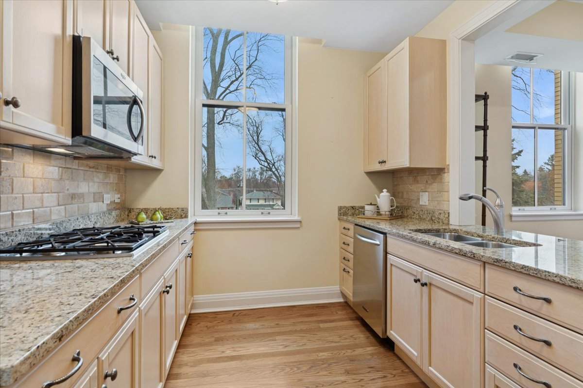 1041 Ridge Road, Unit 304 Wilmette, IL 60091 - Photo 6 of 30 a kitchen with stainless steel appliances granite countertop a stove and a sink