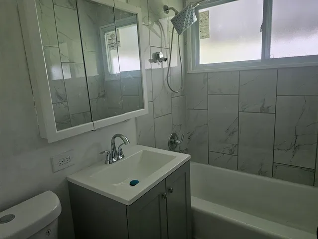 a bathroom with a sink toilet and shower