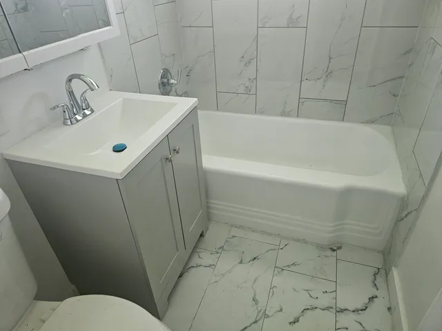 a bathroom with a sink a toilet and bathtub
