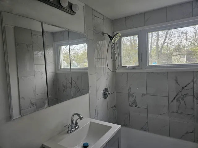 a bathroom with a sink and shower
