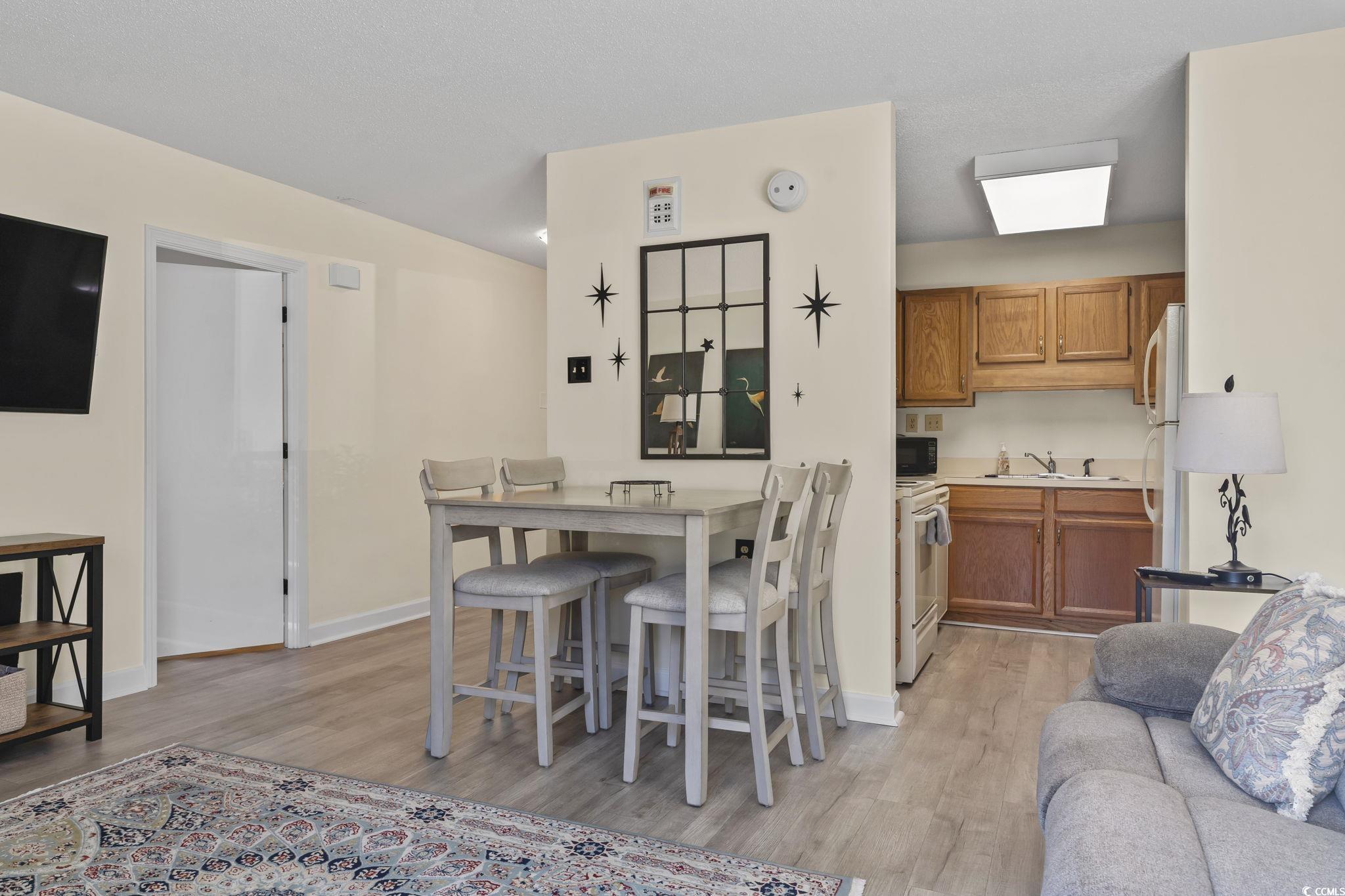 5001 Little River Road, Unit W106 Myrtle Beach, SC 29577 - Photo 5 of 28 Dining space with light wood finished floors