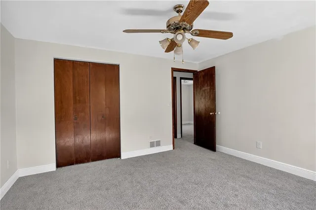 a view of an empty room and closet area