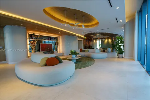a room with lots of furniture and potted plants