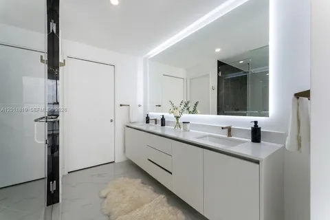 a view of a kitchen with refrigerator and windows