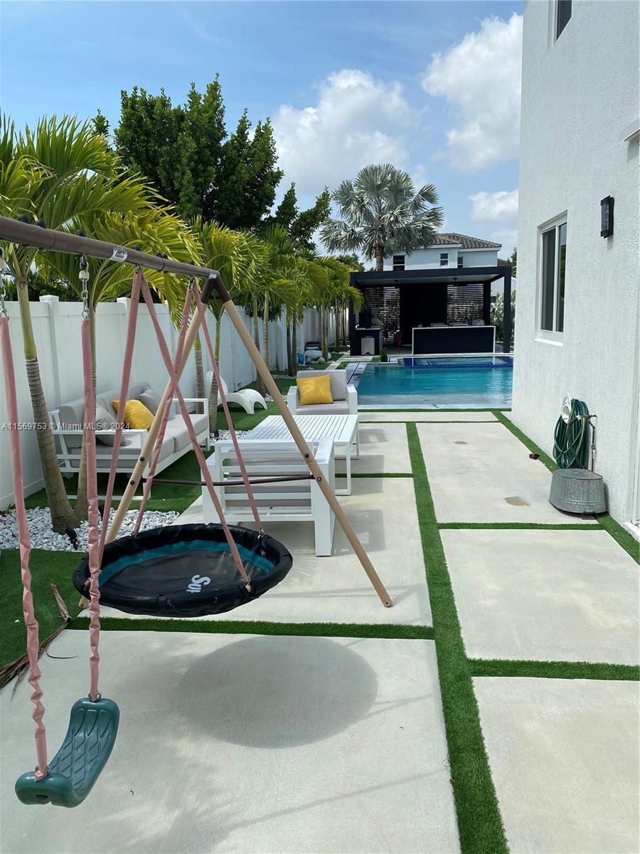 16976 Southwest 90th Terrace Miami, FL 33196 - Photo 16 of 90 a view of a swimming pool with a patio and a garden