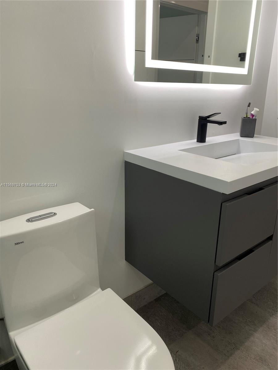 16976 Southwest 90th Terrace Miami, FL 33196 - Photo 40 of 90 a bathroom with a sink toilet and mirror