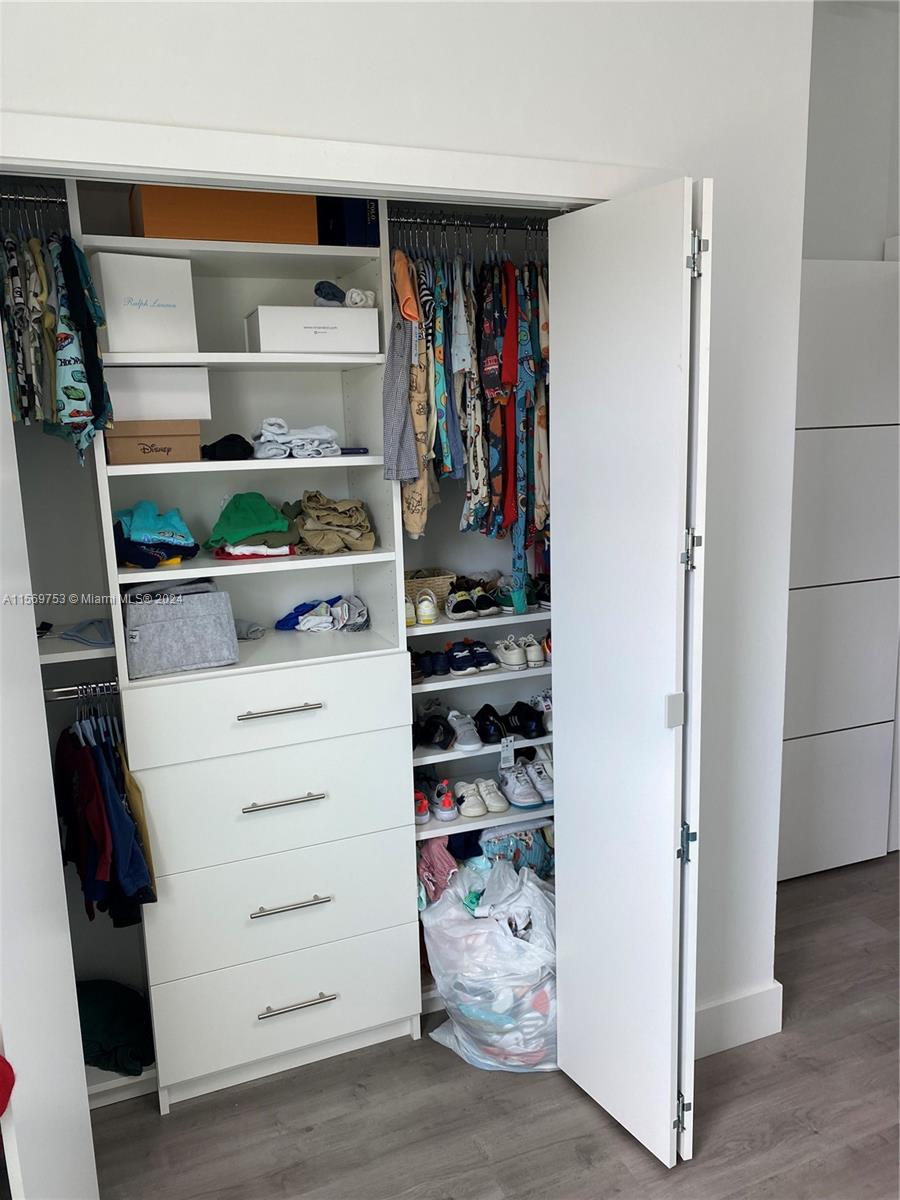 16976 Southwest 90th Terrace Miami, FL 33196 - Photo 53 of 90 a view of walk in closet with clothes and shoes