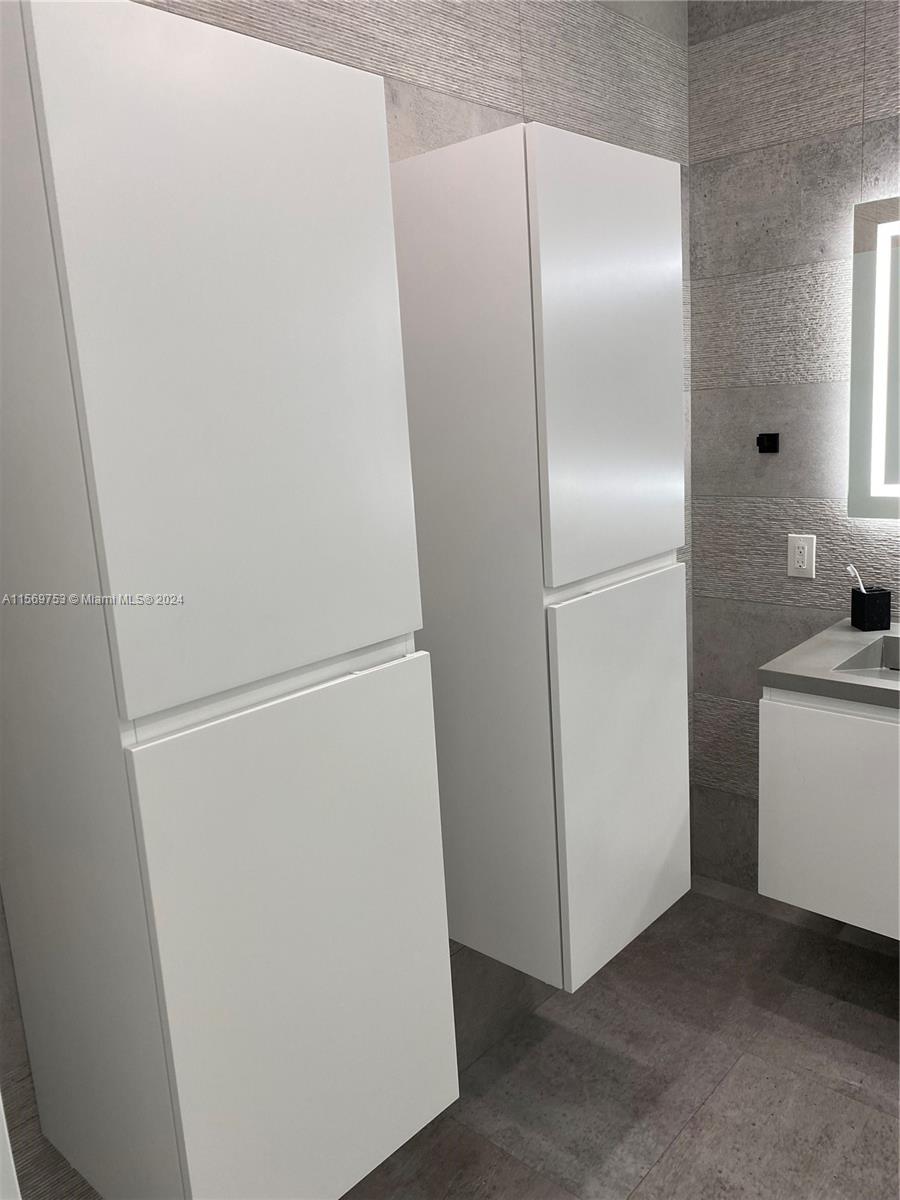 16976 Southwest 90th Terrace Miami, FL 33196 - Photo 67 of 90 a view of a refrigerator in kitchen and white cabinets