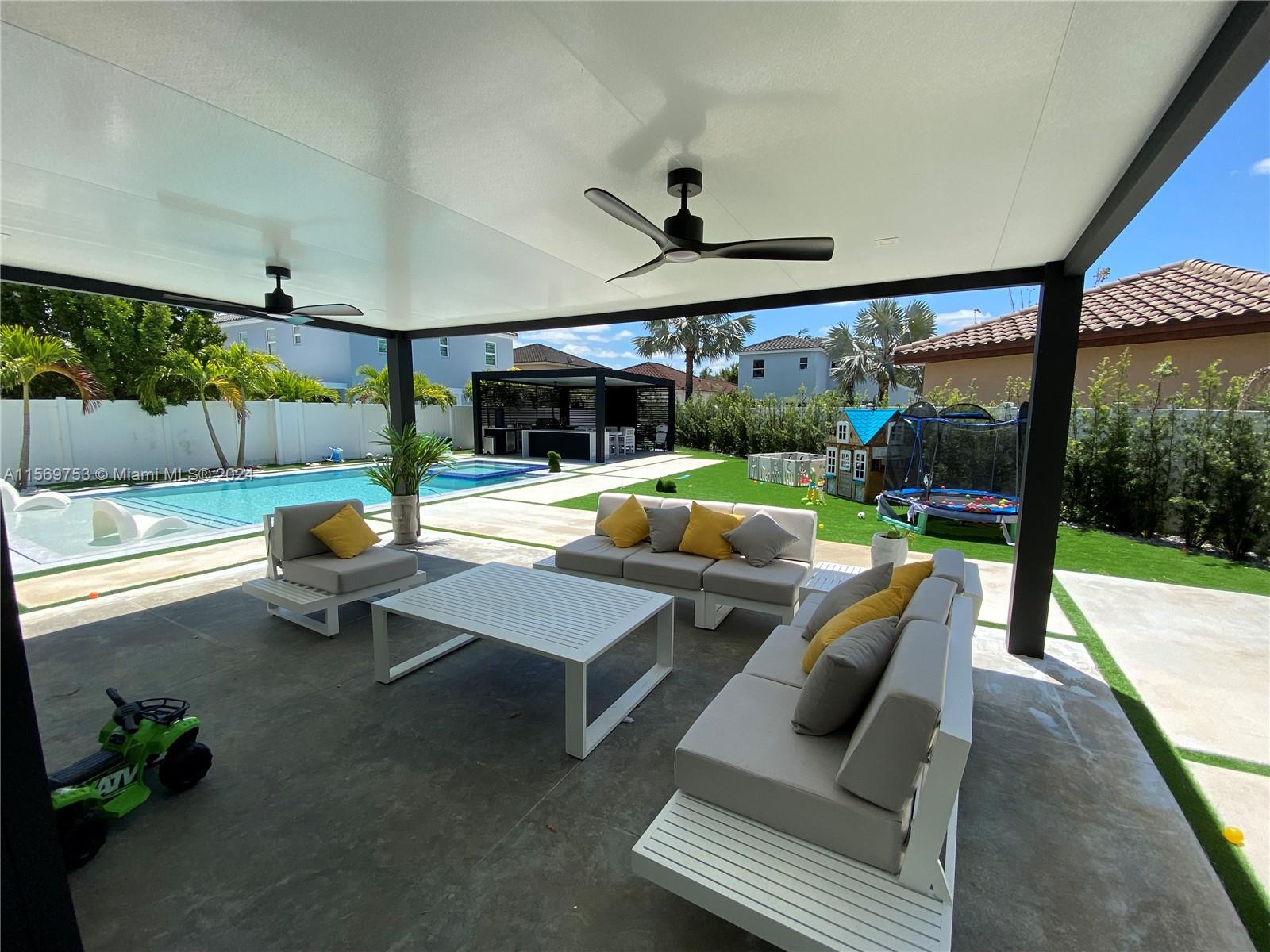 16976 Southwest 90th Terrace Miami, FL 33196 - Photo 80 of 90 a living room with patio furniture and a garden