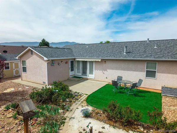 an aerial view of residential houses with outdoor space and parking