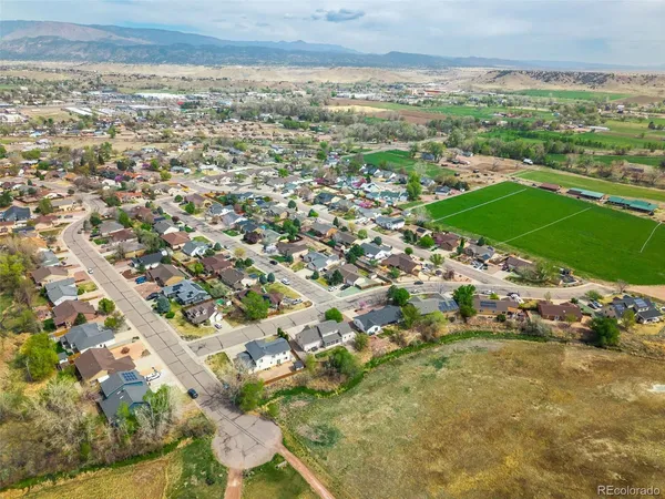 an aerial view of a house with a garden and mountain view