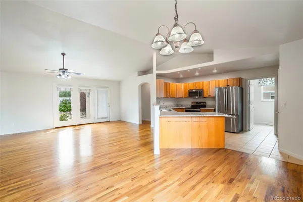 a view of a kitchen with a sink and wooden floor