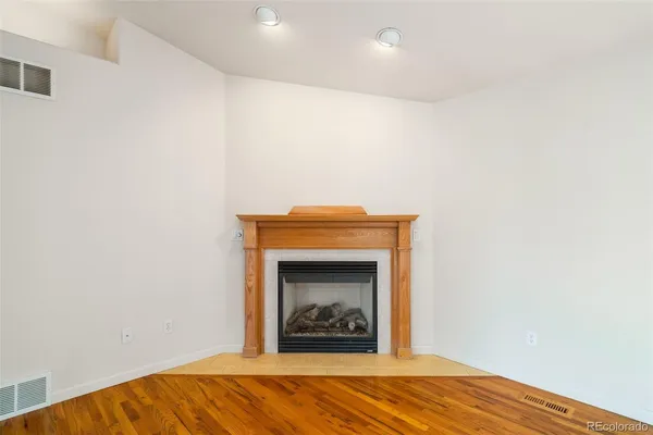 a view of an empty room with a fireplace