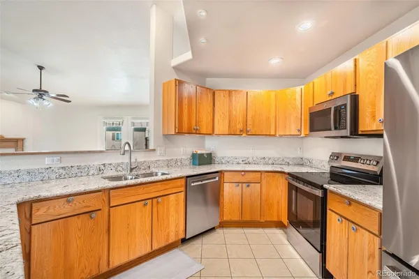 a kitchen with stainless steel appliances granite countertop a sink stove microwave and cabinets