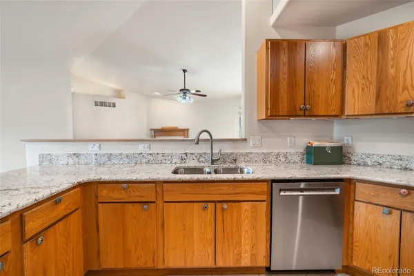 a kitchen with stainless steel appliances granite countertop a sink and cabinets