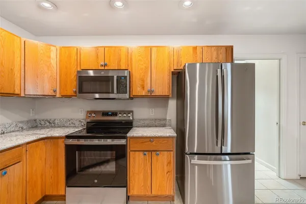 a kitchen with stainless steel appliances a stove microwave and refrigerator