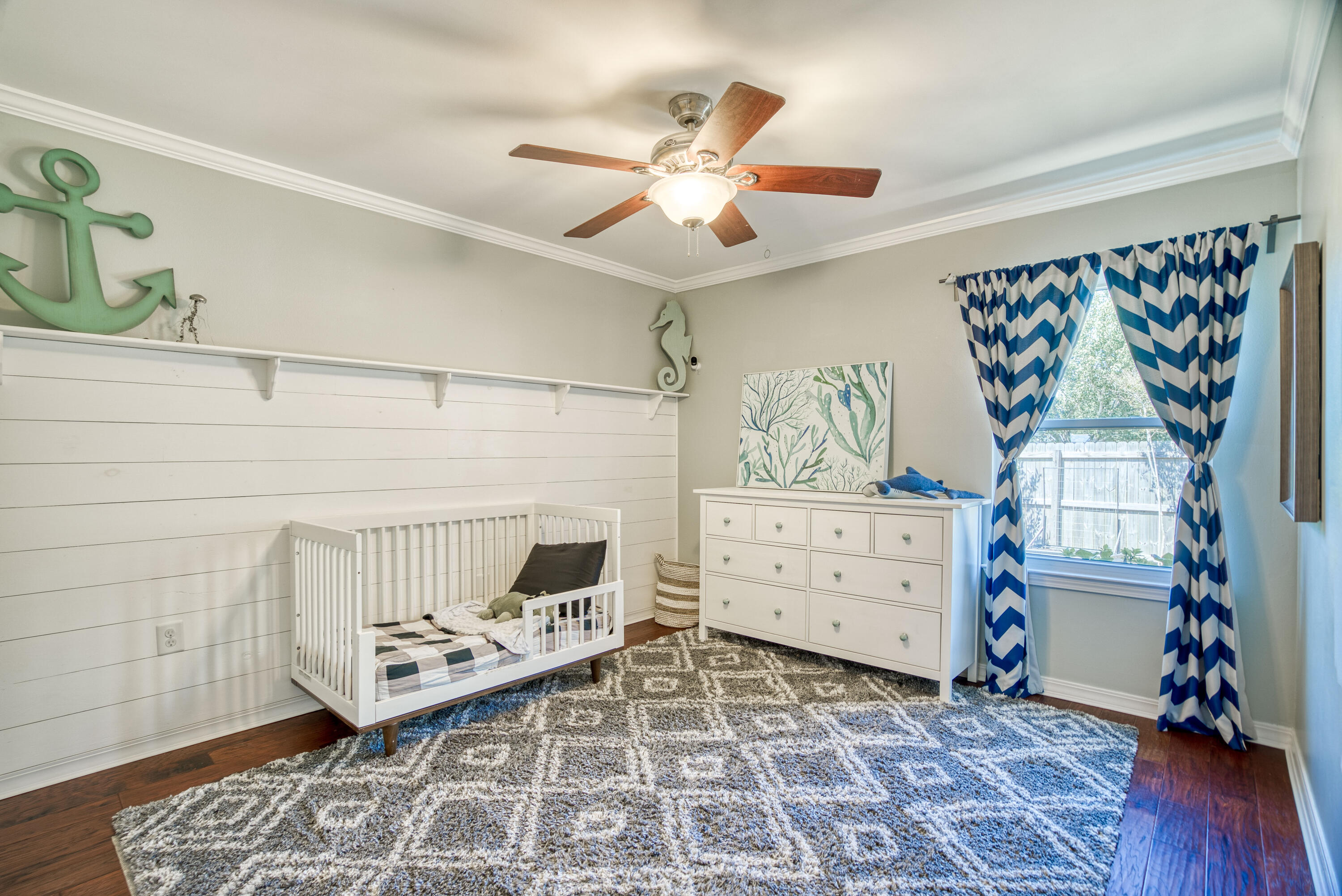 3937 Mesa Road Destin, FL 32541 - Photo 21 of 60 a bedroom with a baby bed and a window