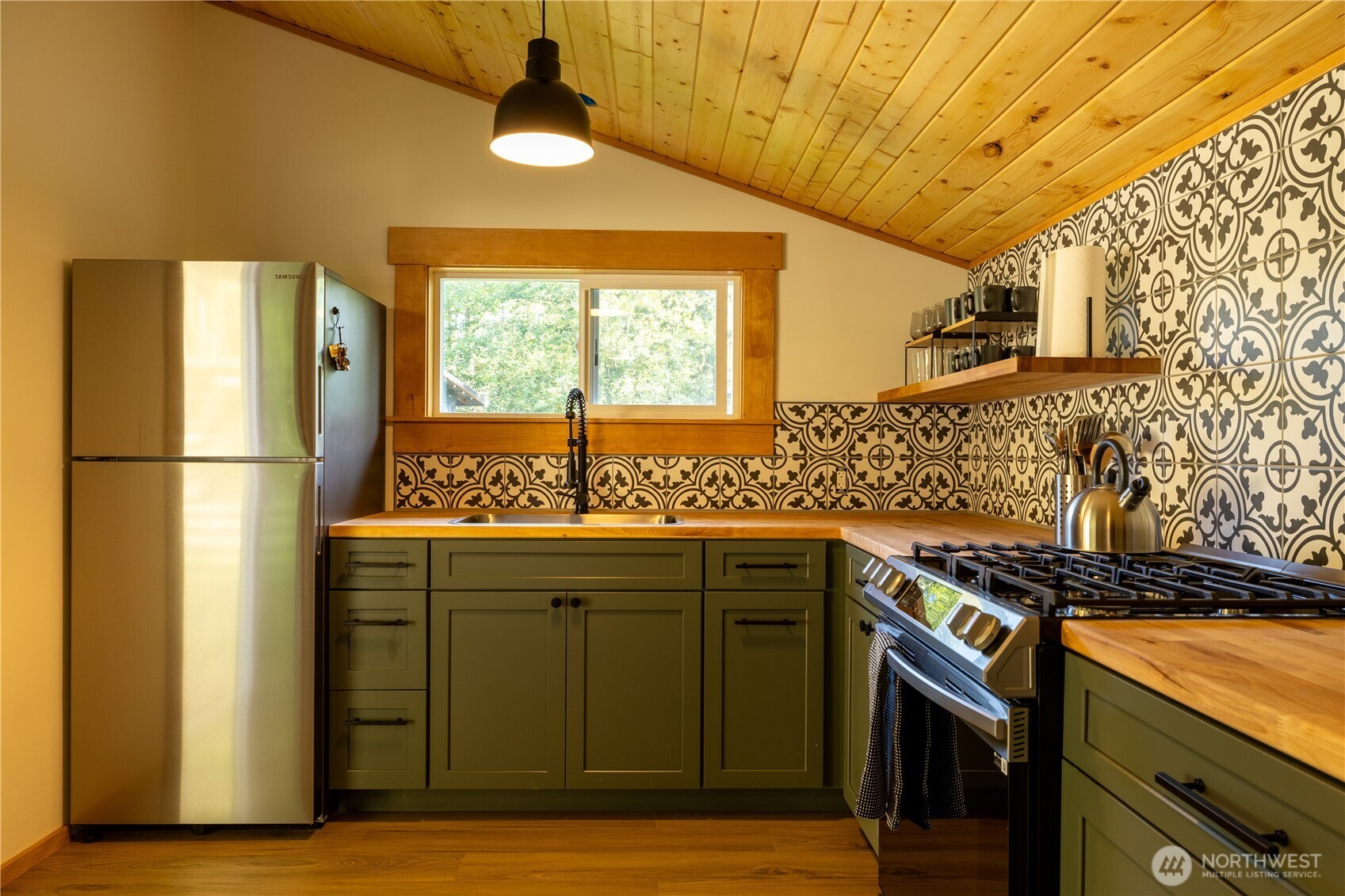 430 Twilight Way Grapeview, WA 98546 - Photo 19 of 22 a kitchen with stainless steel appliances granite countertop a stove a refrigerator and a sink
