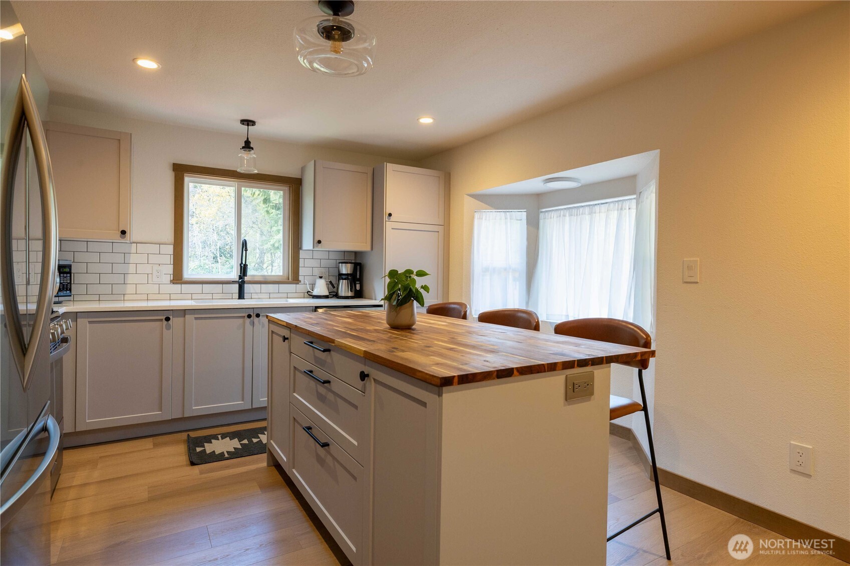 430 Twilight Way Grapeview, WA 98546 - Photo 5 of 22 a kitchen with a sink window and cabinets
