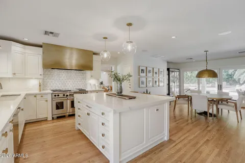 a kitchen with kitchen island granite countertop wooden floors and center island