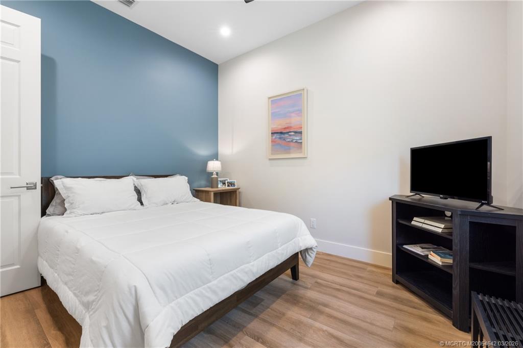 5169 Southeast Horseshoe Point Road Stuart, FL 34997 - Photo 25 of 54 a bedroom with a bed and a flat screen tv