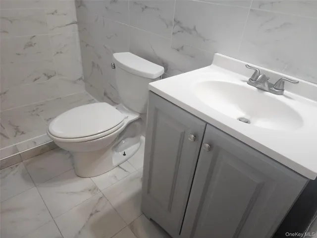 a white toilet sitting next to a bathroom sink