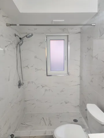 a bathroom with a toilet and shower