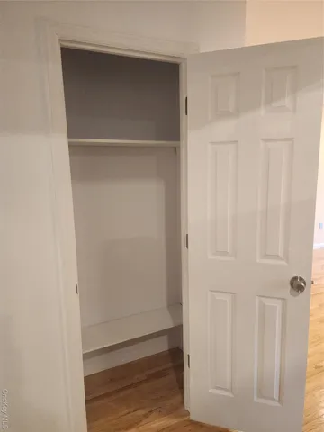a view of walk in closet with empty racks