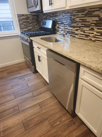 a view of a kitchen counter space and wooden floor