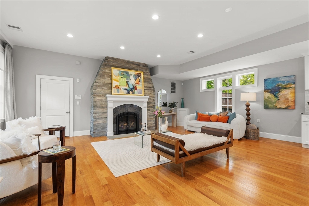 165 Park Avenue, Unit 165 Arlington, MA 02476 - Photo 7 of 32 a living room with furniture a fireplace and a table