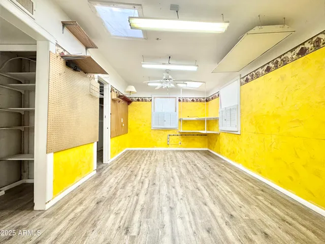 a view of empty room with wooden floor and windows