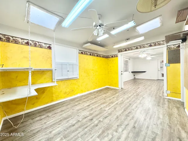 a view of a room with wooden floor and a tub