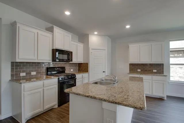 a kitchen with sink microwave and stove